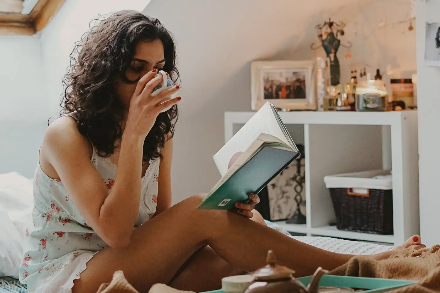 Woman reading a book and having breakfast