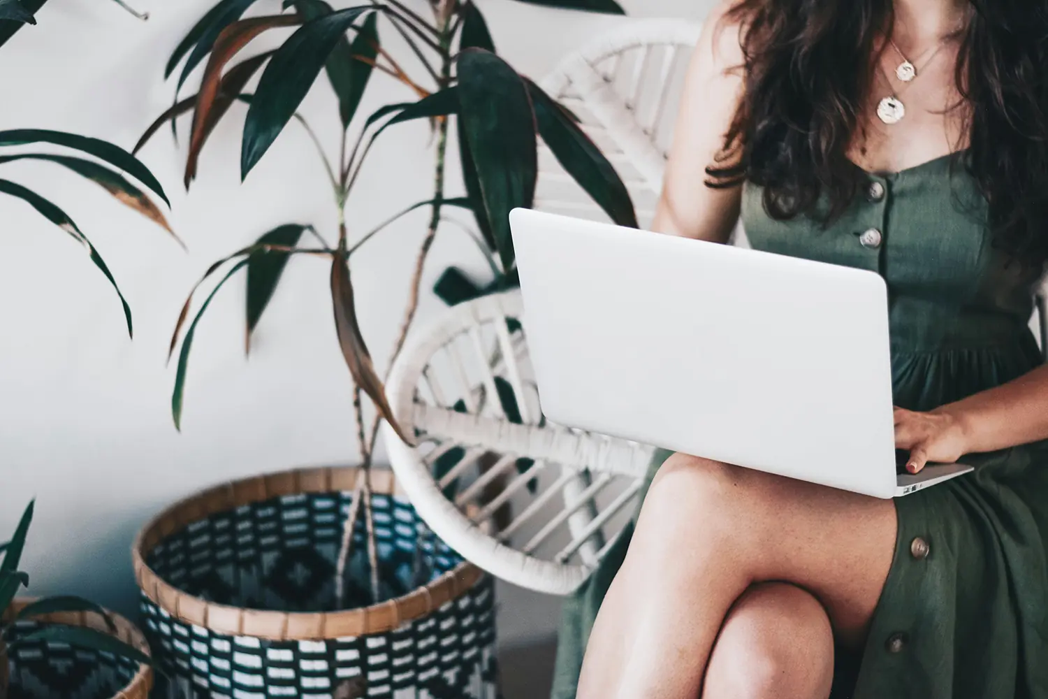 A woman sitting at home working on her laptop