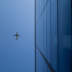 Airplane flying over building